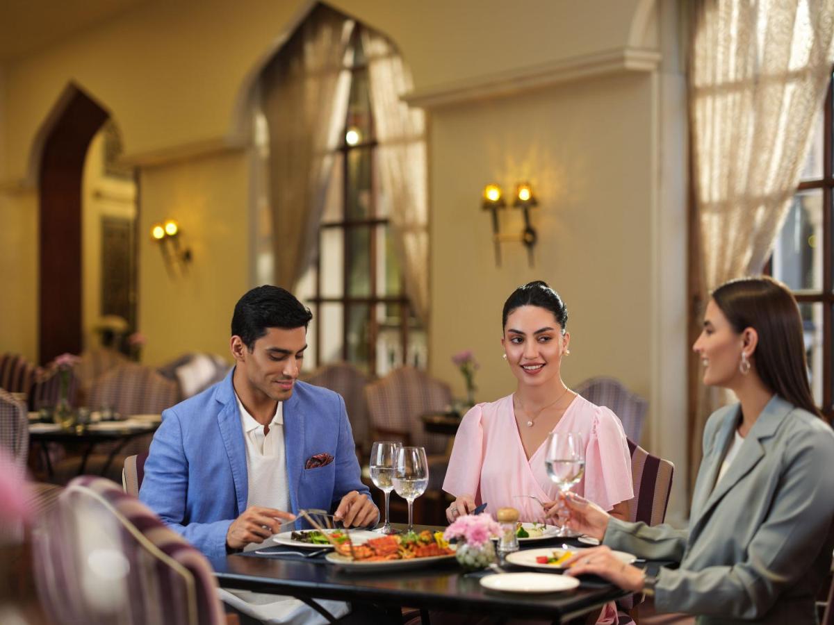 a group of people sitting at a table in a restaurant at Taj Krishna in Hyderabad