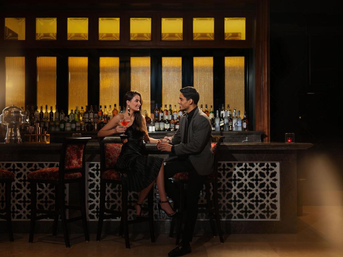 a man and a woman sitting at a bar at Taj Krishna in Hyderabad