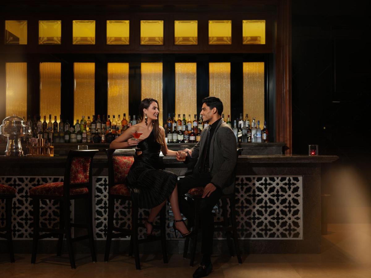 a man and a woman sitting at a bar at Taj Krishna in Hyderabad