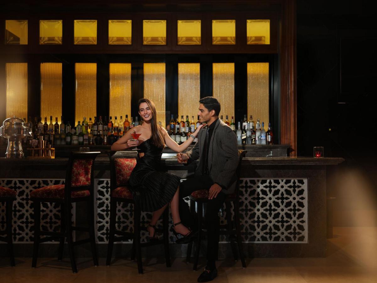 a man and a woman sitting at a bar at Taj Krishna in Hyderabad