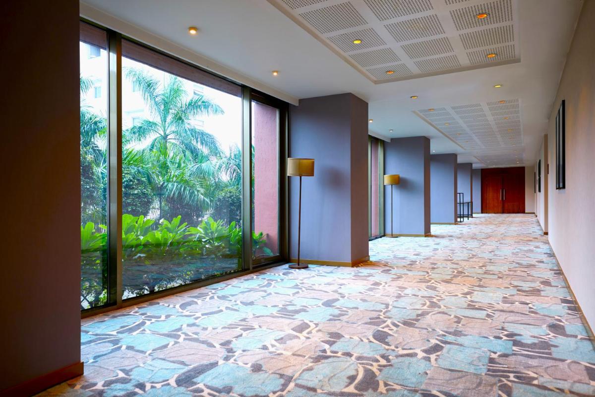 an empty hallway with a view of an aquarium at Hyatt Place Pune Hinjawadi in Pune