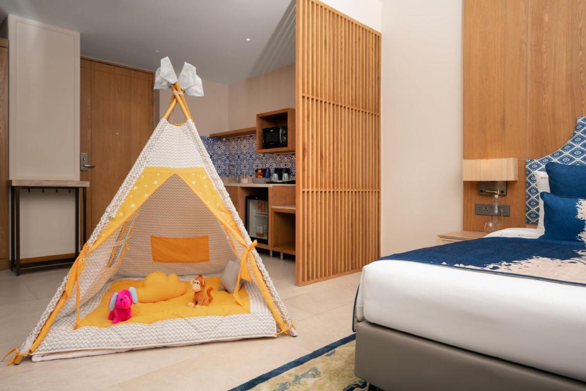 a bedroom with a play tent with toys in it at The Astor - All Suites Hotel Candolim Goa in Candolim a bedroom with a play tent with toys in it at The Astor - All Suites Hotel Candolim Goa in Candolim