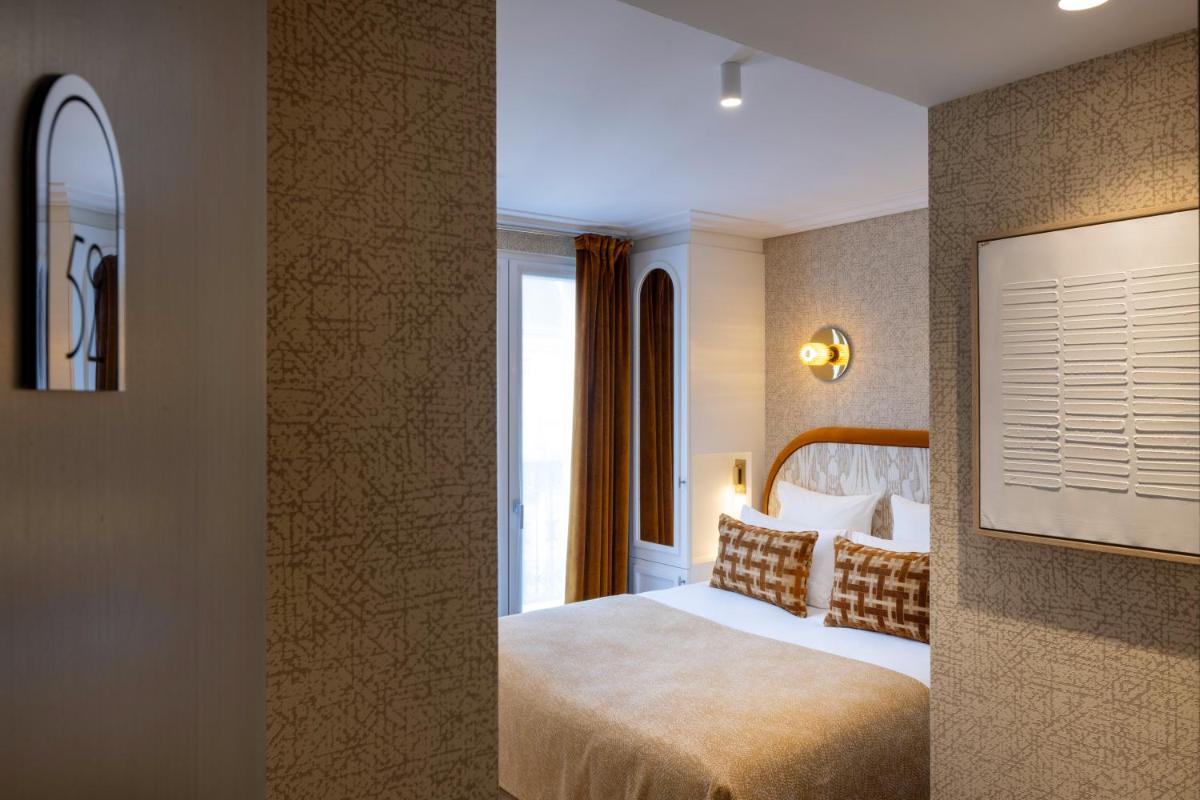 Un ou plusieurs lits dans un hébergement de l'établissement Hotel des Carmes by Malone