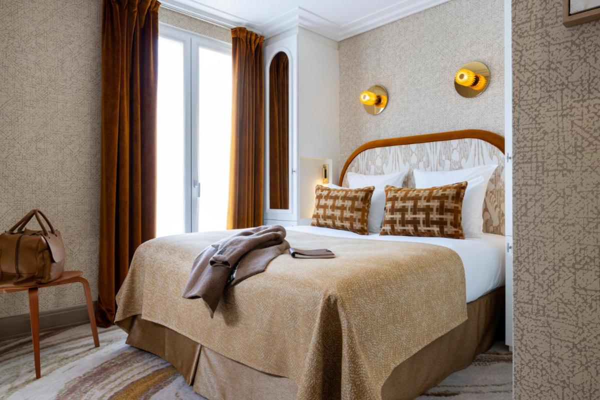 Un ou plusieurs lits dans un hébergement de l'établissement Hotel des Carmes by Malone