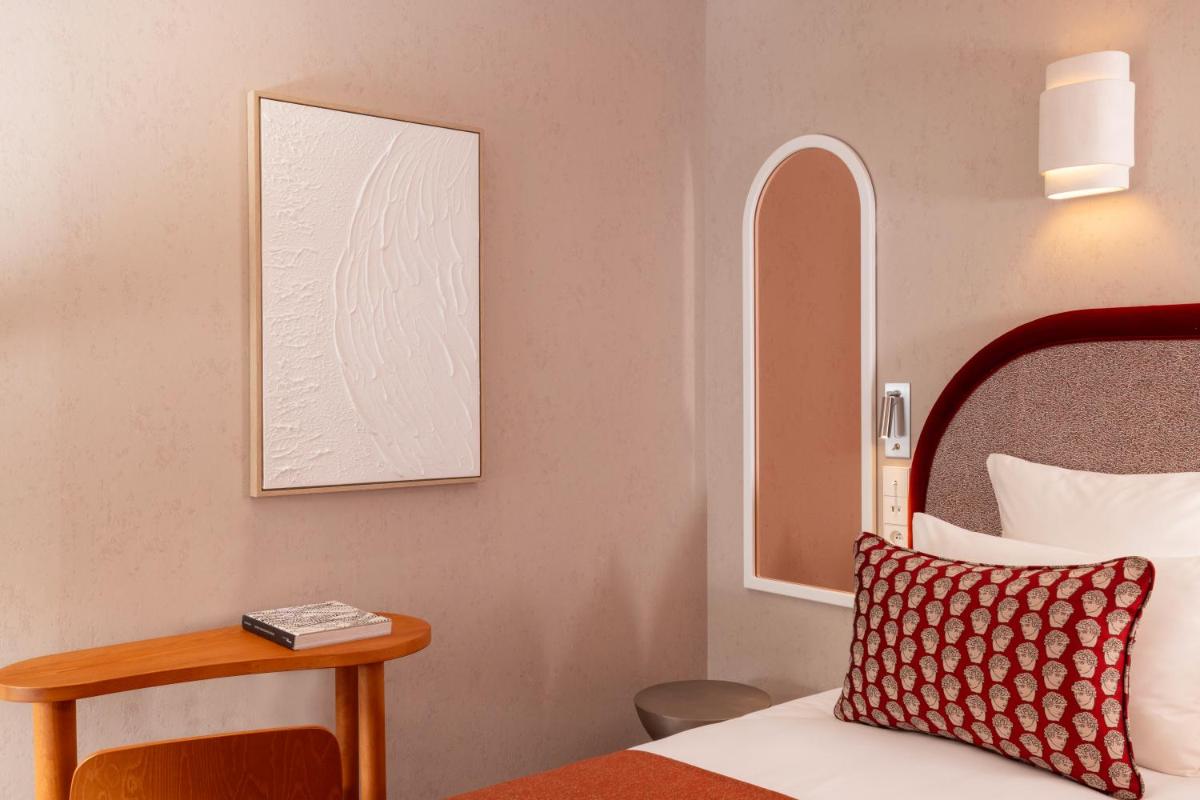Un ou plusieurs lits dans un hébergement de l'établissement Hotel des Carmes by Malone
