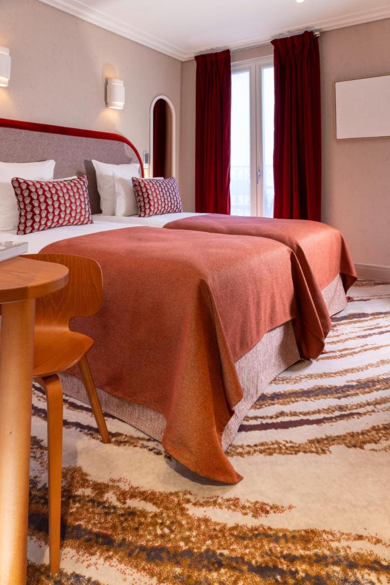 Un ou plusieurs lits dans un hébergement de l'établissement Hotel des Carmes by Malone