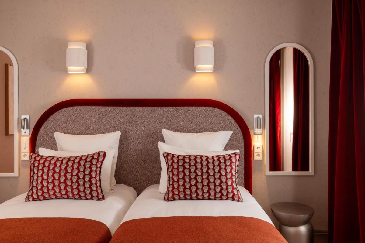 Un ou plusieurs lits dans un hébergement de l'établissement Hotel des Carmes by Malone