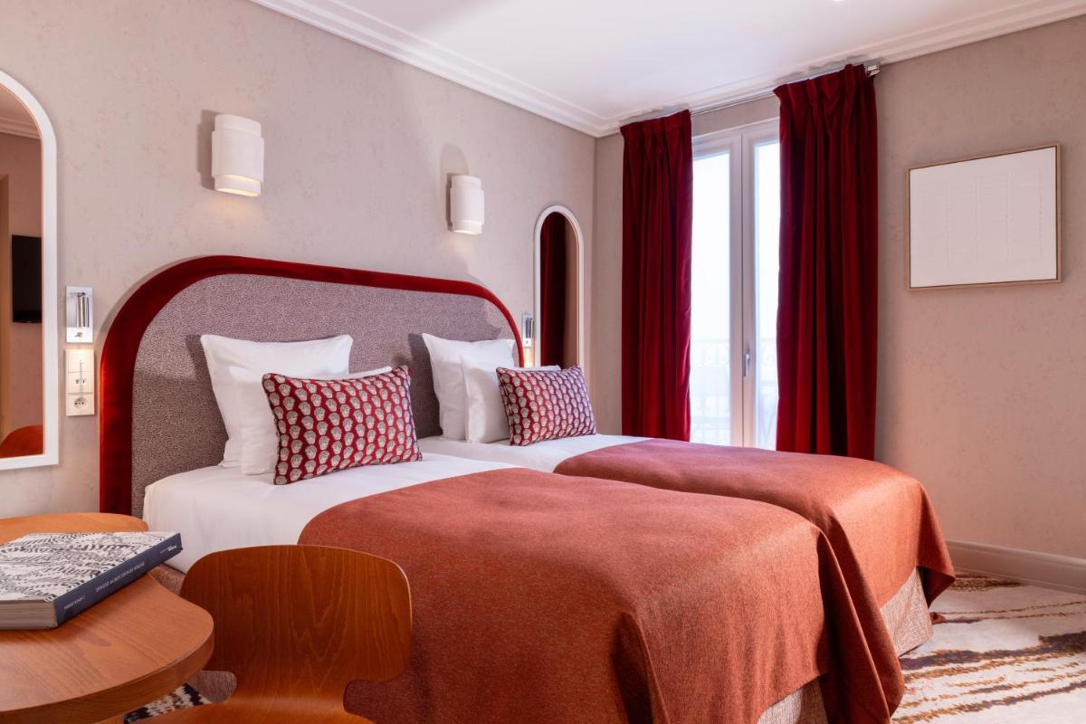 Un ou plusieurs lits dans un hébergement de l'établissement Hotel des Carmes by Malone