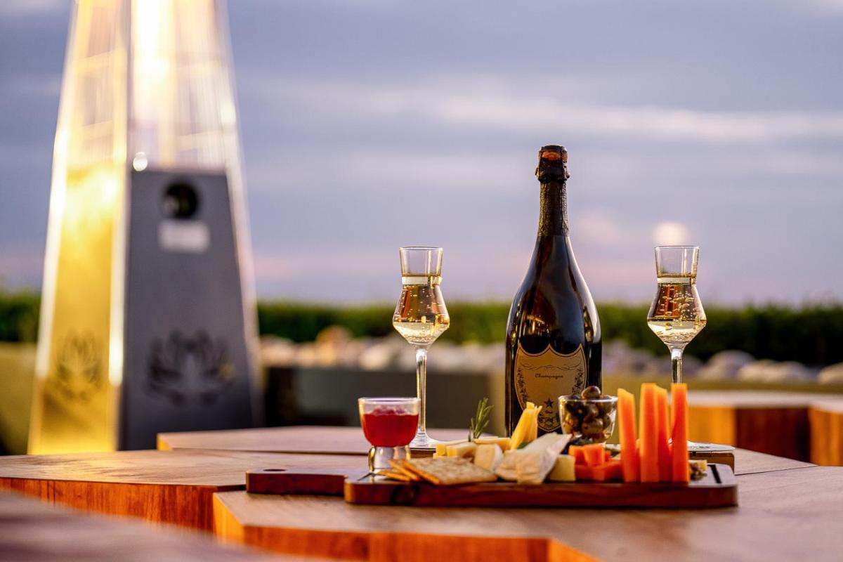 a table with a bottle of wine and two glasses at The Westin Resort & Spa Himalayas in Rishīkesh