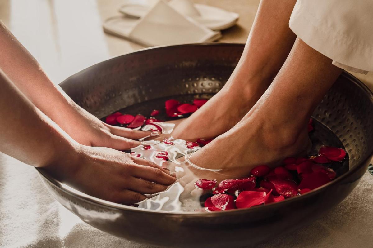 two people soaking their feet in a bowl of food at The Westin Resort & Spa Himalayas in Rishīkesh