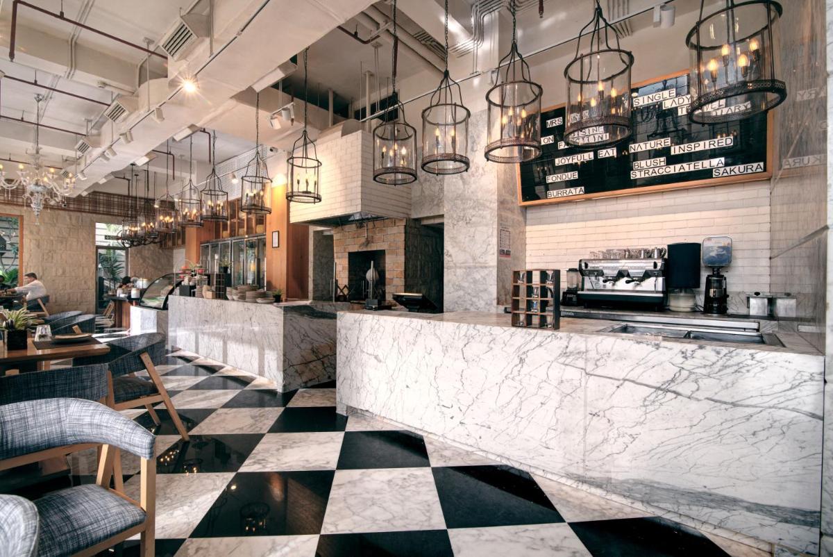 a restaurant with a black and white checkered floor at Hyatt Ahmedabad in Ahmedabad