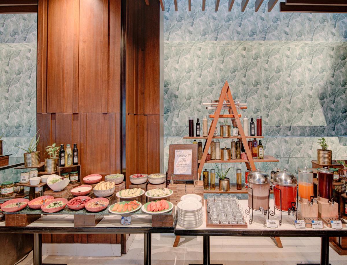 a table with many different types of food on it at Hyatt Ahmedabad in Ahmedabad