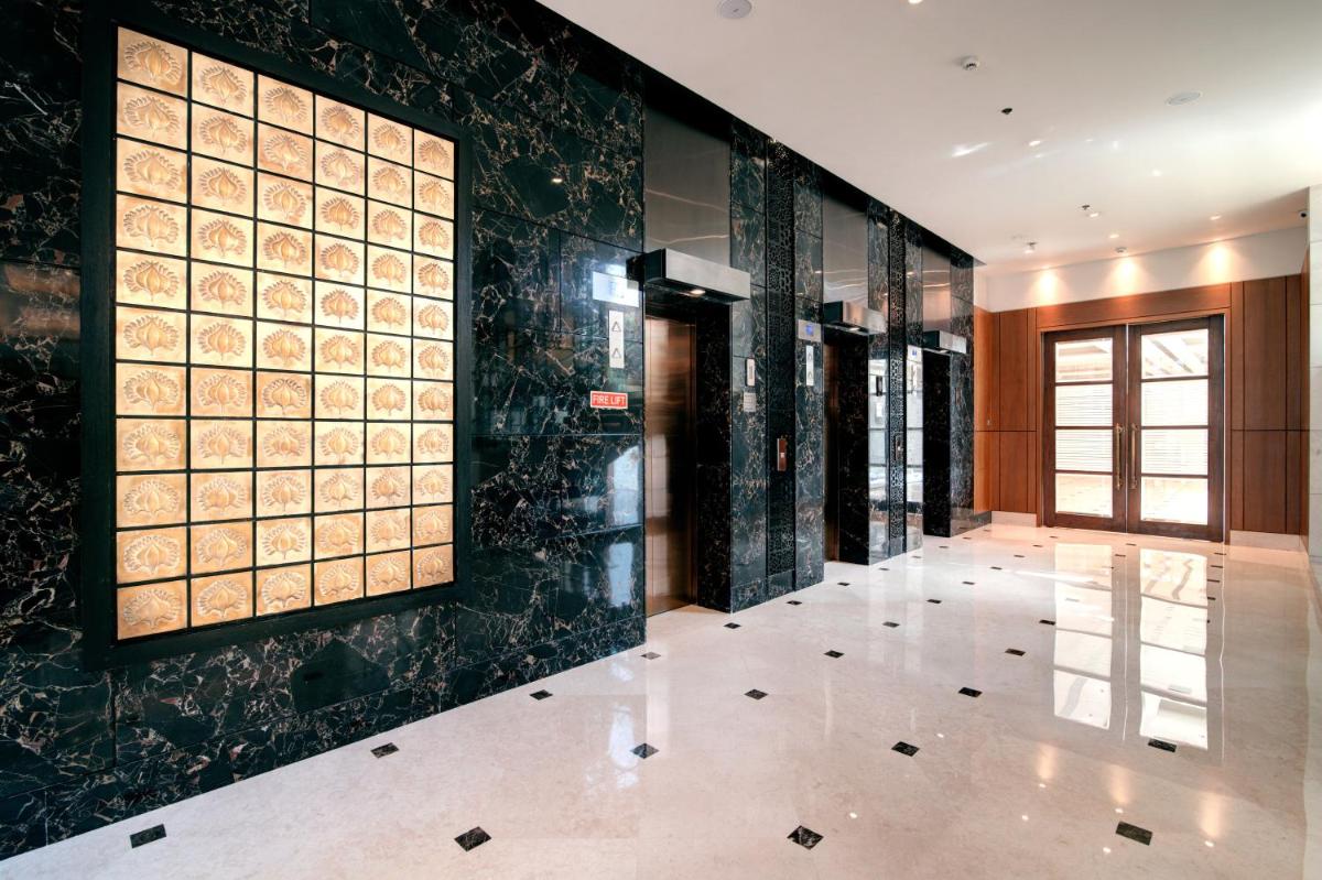 a hallway of a building with black and gold tiles at Hyatt Ahmedabad in Ahmedabad