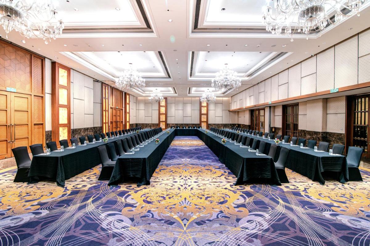 a large room with rows of tables and chairs at Hyatt Ahmedabad in Ahmedabad