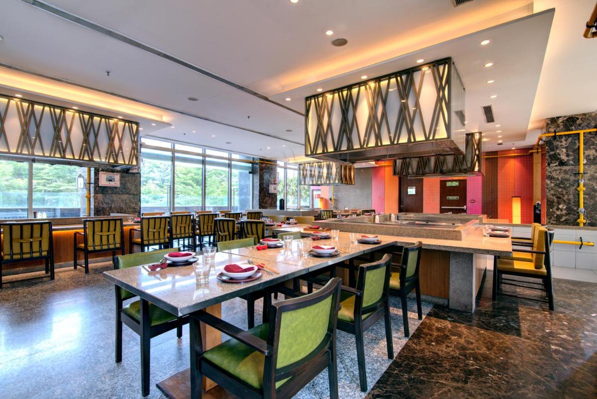 a dining room with a table and chairs at Hyatt Ahmedabad in Ahmedabad