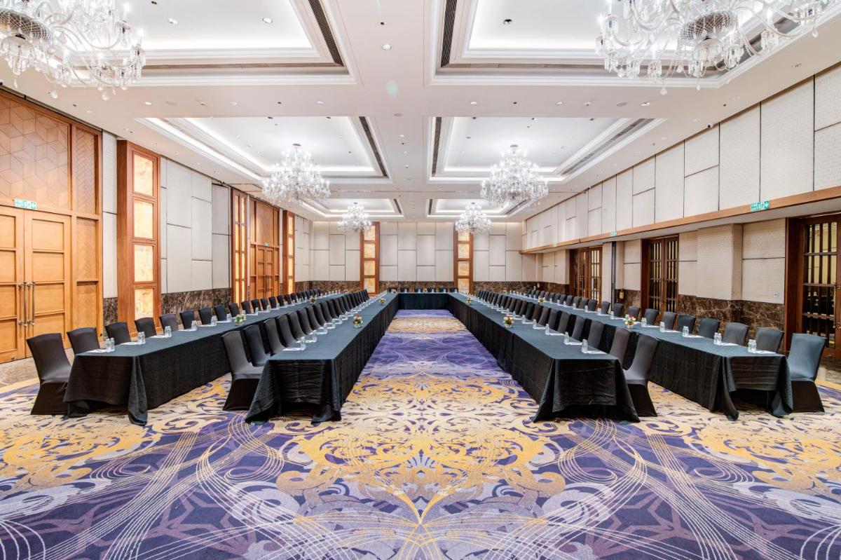 a large room with rows of tables and chairs at Hyatt Ahmedabad in Ahmedabad