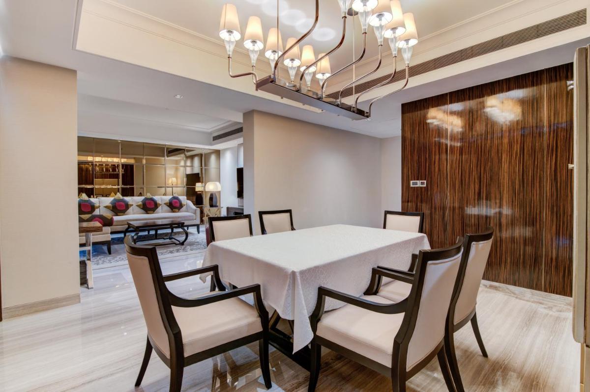 a dining room with a white table and chairs at Hyatt Ahmedabad in Ahmedabad