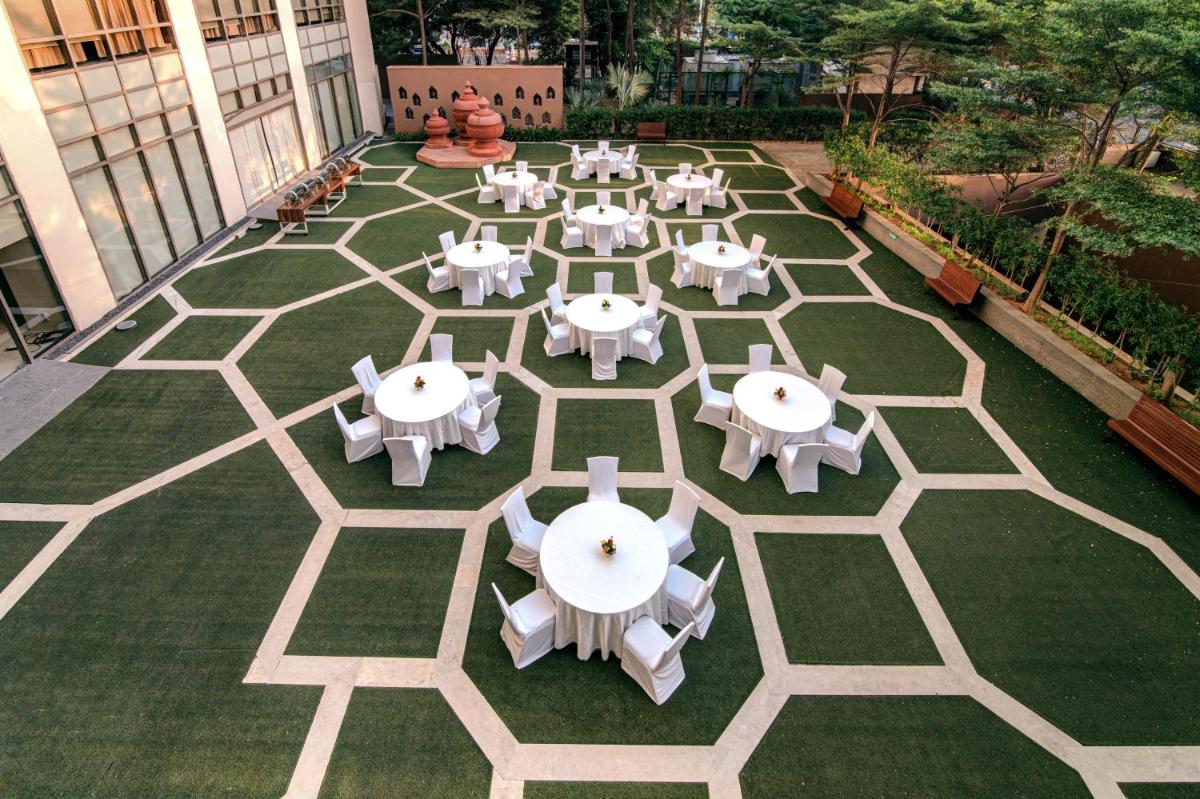an overhead view of a patio with tables and chairs at Hyatt Ahmedabad in Ahmedabad