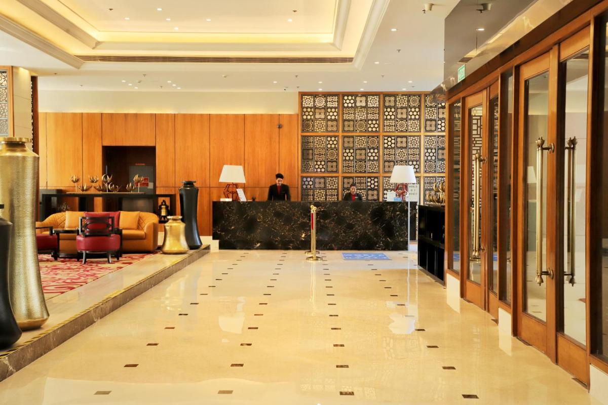 a lobby of a hotel with a reception desk at Hyatt Ahmedabad in Ahmedabad