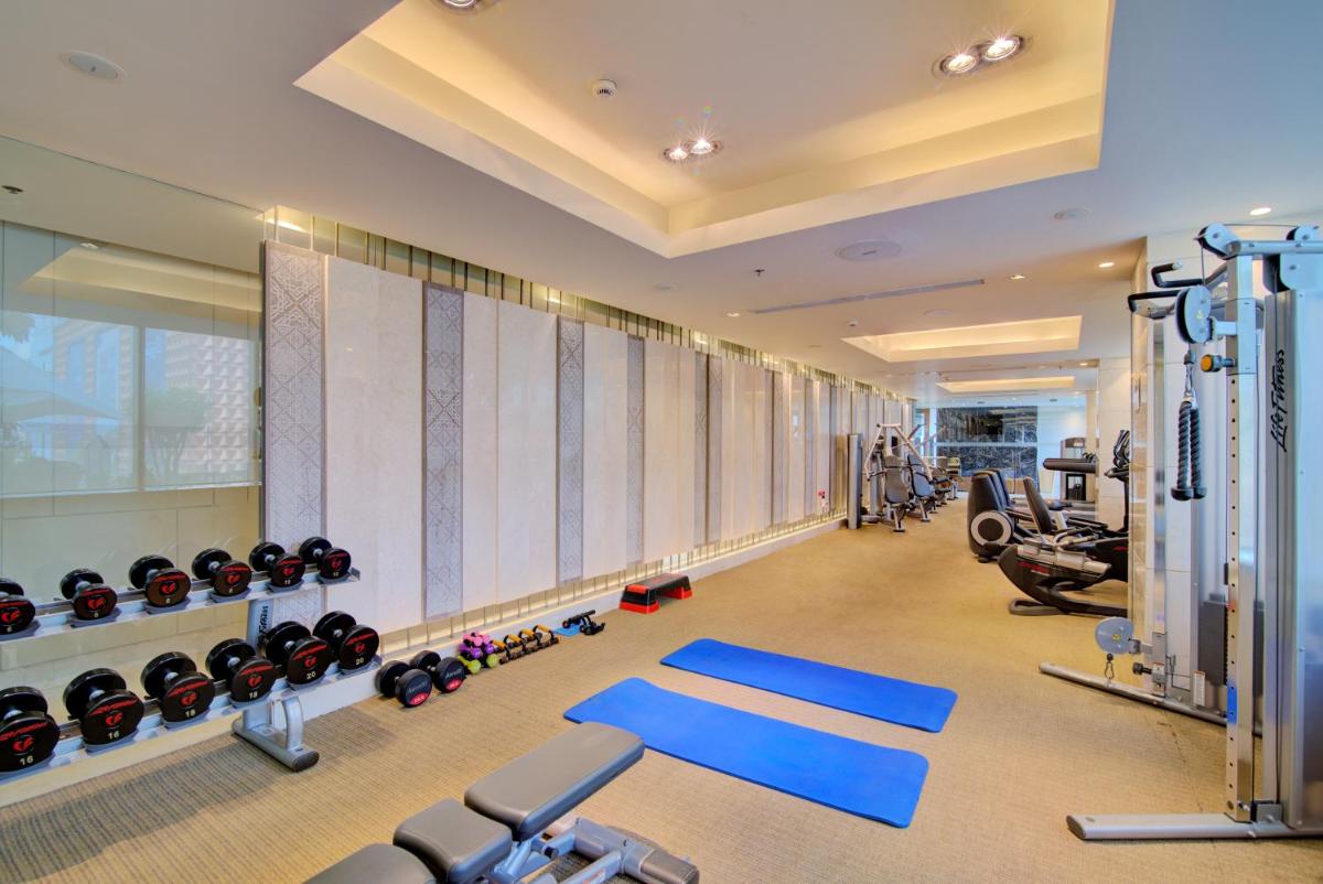 a gym with treadmills and equipment in a building at Hyatt Ahmedabad in Ahmedabad