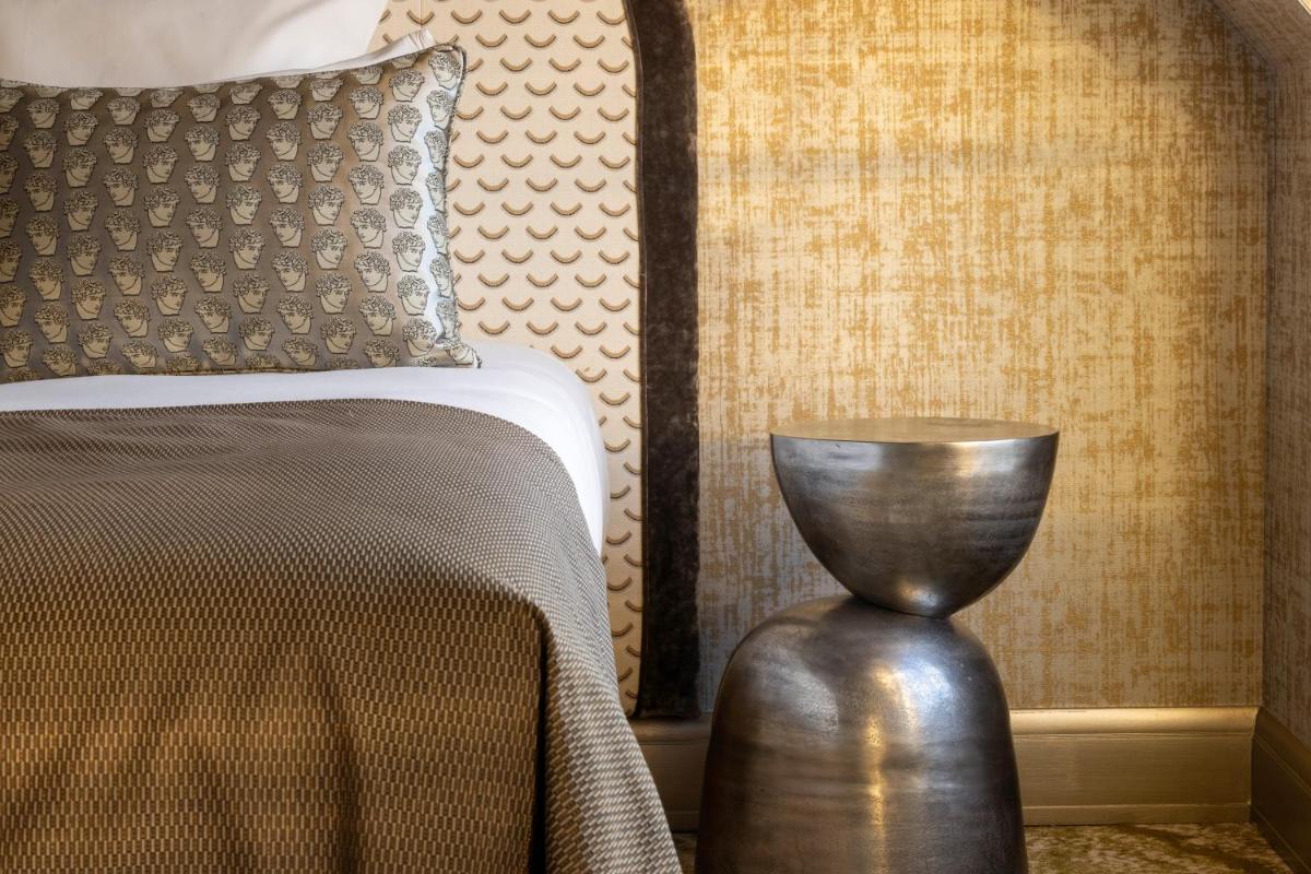 Un ou plusieurs lits dans un hébergement de l'établissement Hotel des Carmes by Malone