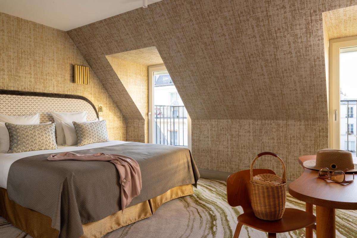 Un ou plusieurs lits dans un hébergement de l'établissement Hotel des Carmes by Malone