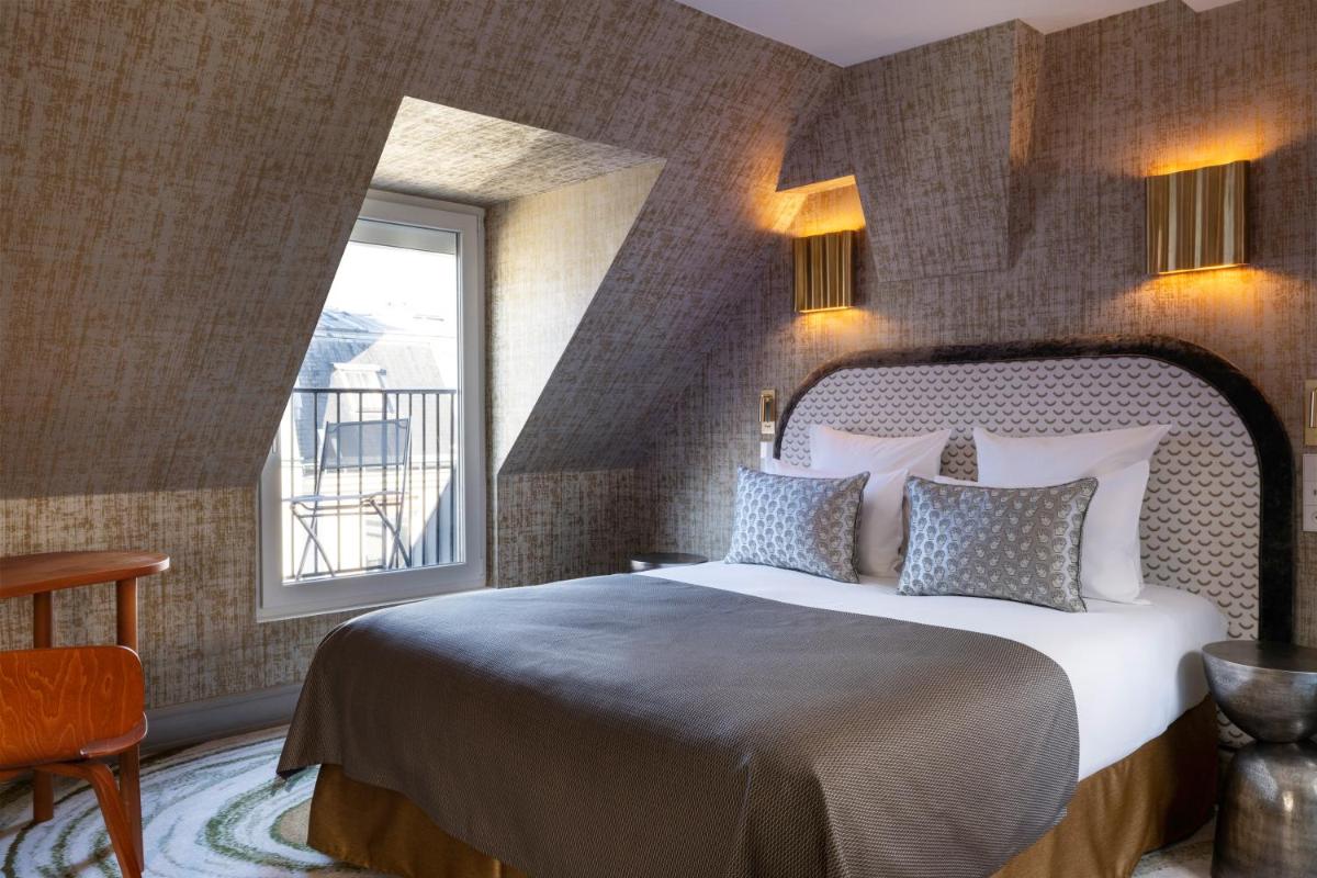 Un ou plusieurs lits dans un hébergement de l'établissement Hotel des Carmes by Malone