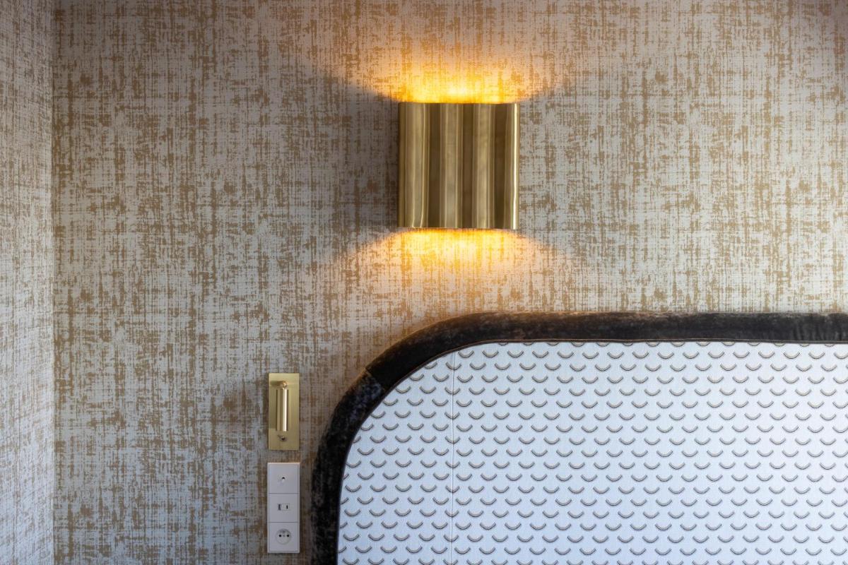 Un ou plusieurs lits dans un hébergement de l'établissement Hotel des Carmes by Malone