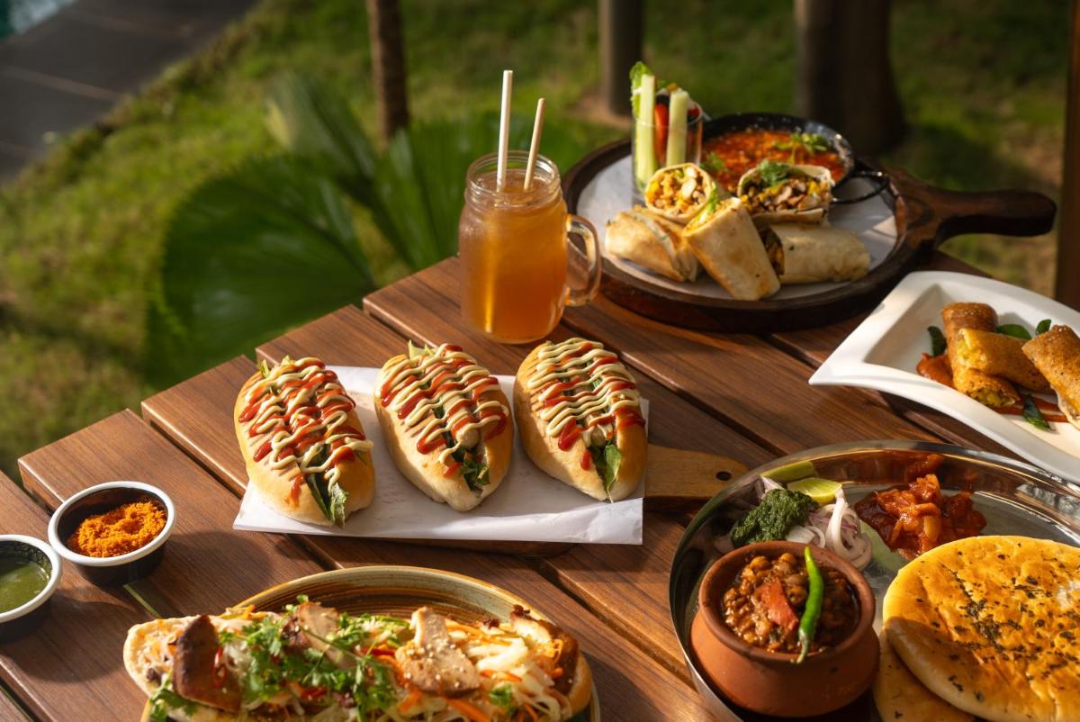 a table with a bunch of hot dogs and drinks at Hyatt Centric MG Road Bangalore in Bengaluru a table with a bunch of hot dogs and drinks at Hyatt Centric MG Road Bangalore in Bengaluru