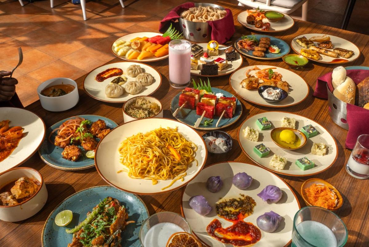 a table with many plates of food on it at Hyatt Centric MG Road Bangalore in Bengaluru a table with many plates of food on it at Hyatt Centric MG Road Bangalore in Bengaluru