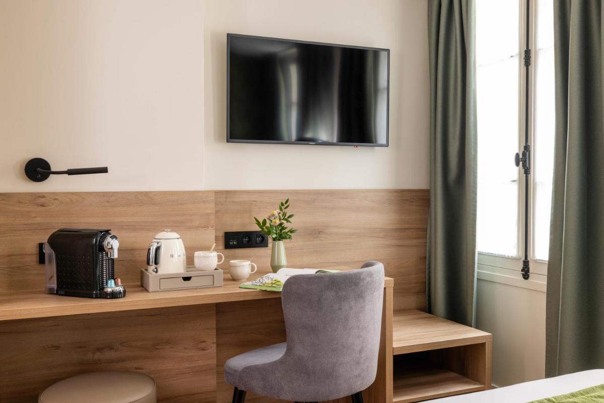 Télévision ou salle de divertissement dans l'établissement Hôtel Théorème