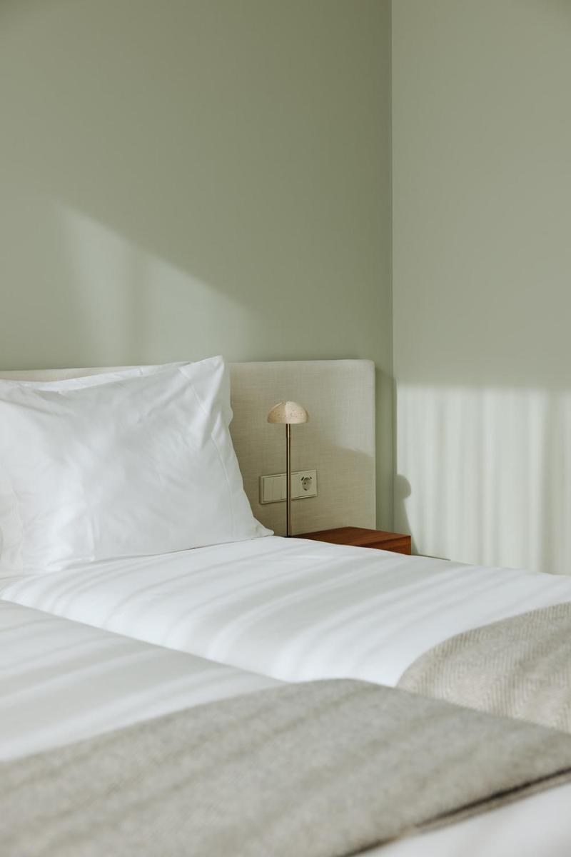 Uma cama ou camas num quarto em NINE DOTS Azorean Art Boutique Hotel