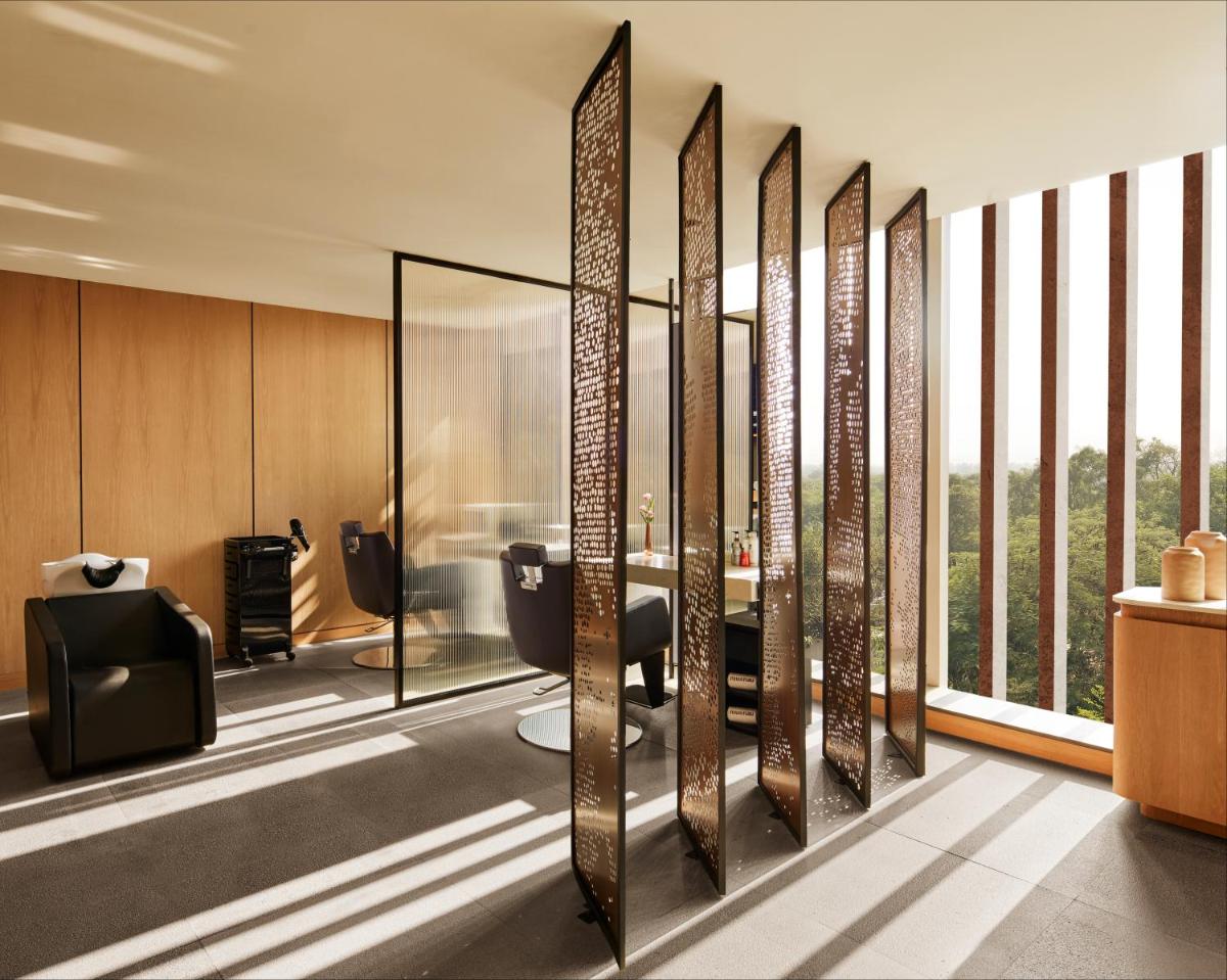 a bathroom with a glass wall with a view at Taj The Trees, Mumbai in Mumbai