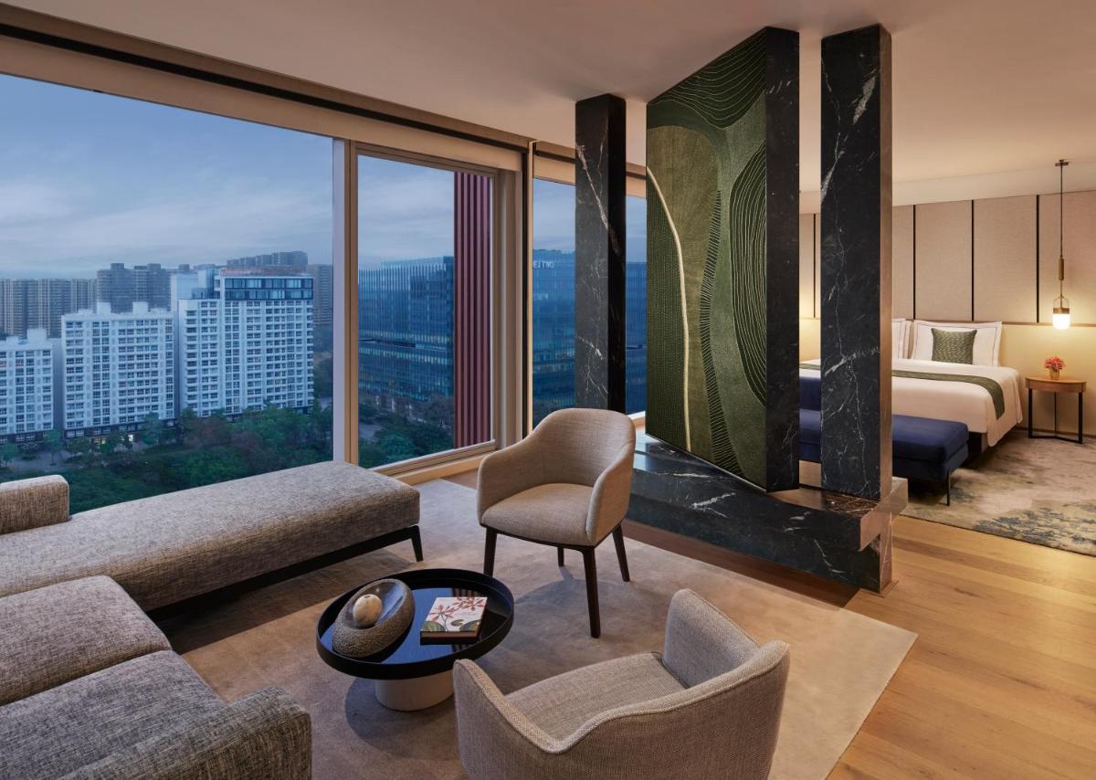 a hotel room with a bed and a large window at Taj The Trees, Mumbai in Mumbai