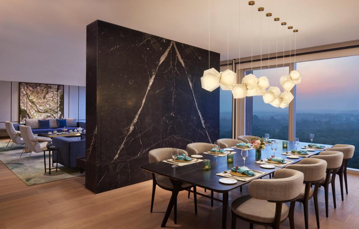 a dining room with a long table and chairs at Taj The Trees, Mumbai in Mumbai