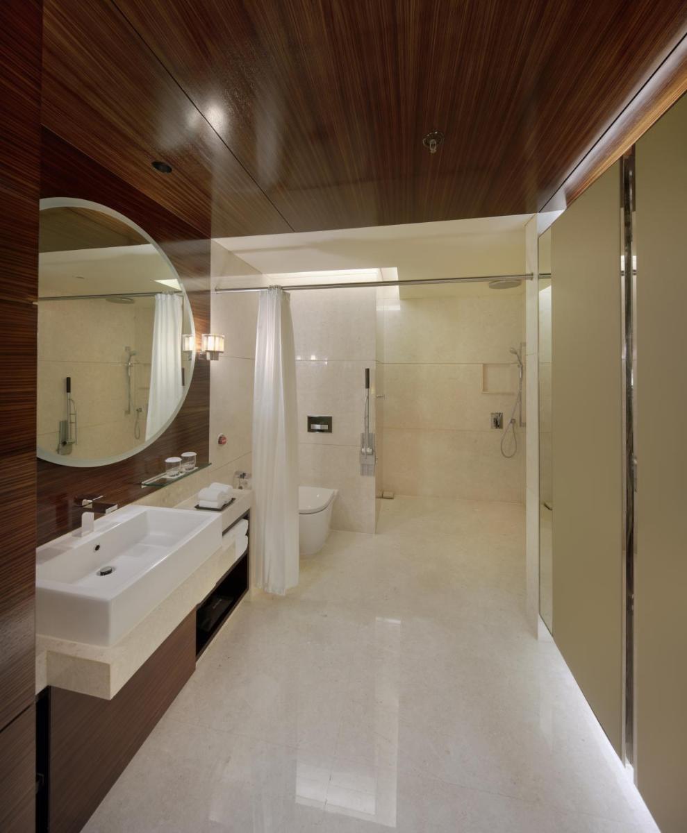 a bathroom with a sink and a mirror at JW Marriott Pune in Pune