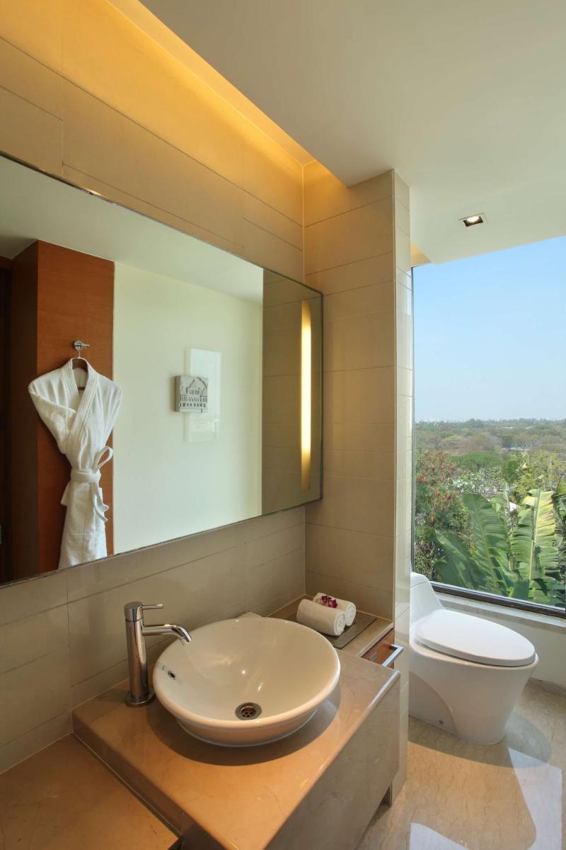 a bathroom with a sink and a toilet and a mirror at Hyatt Pune in Pune
