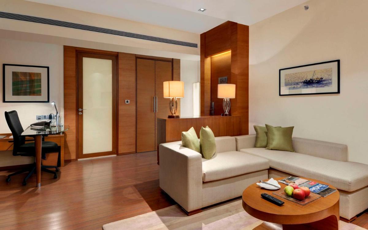 a living room with a couch and a table at Hyatt Pune in Pune