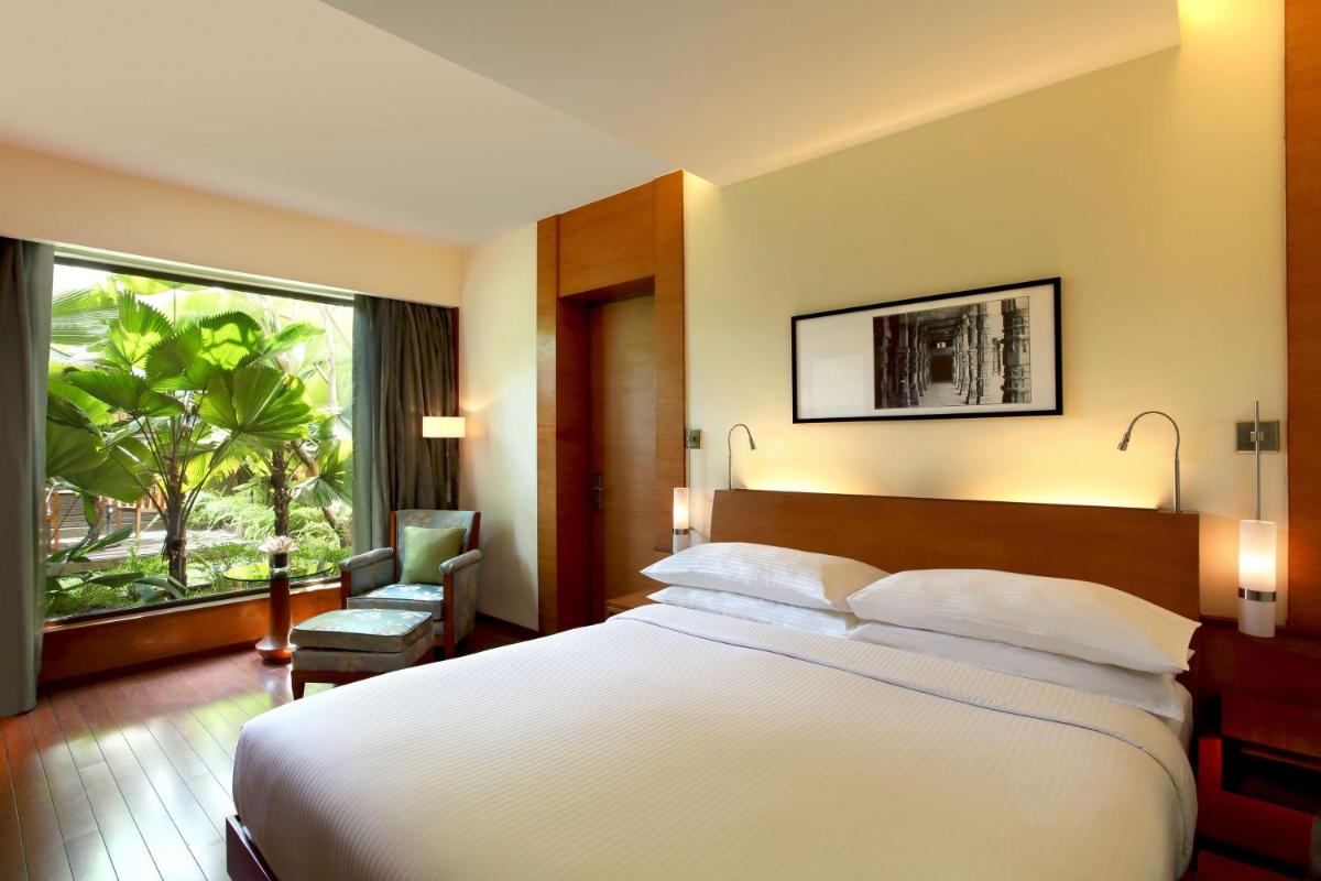 a hotel room with a large bed and a window at Hyatt Pune in Pune