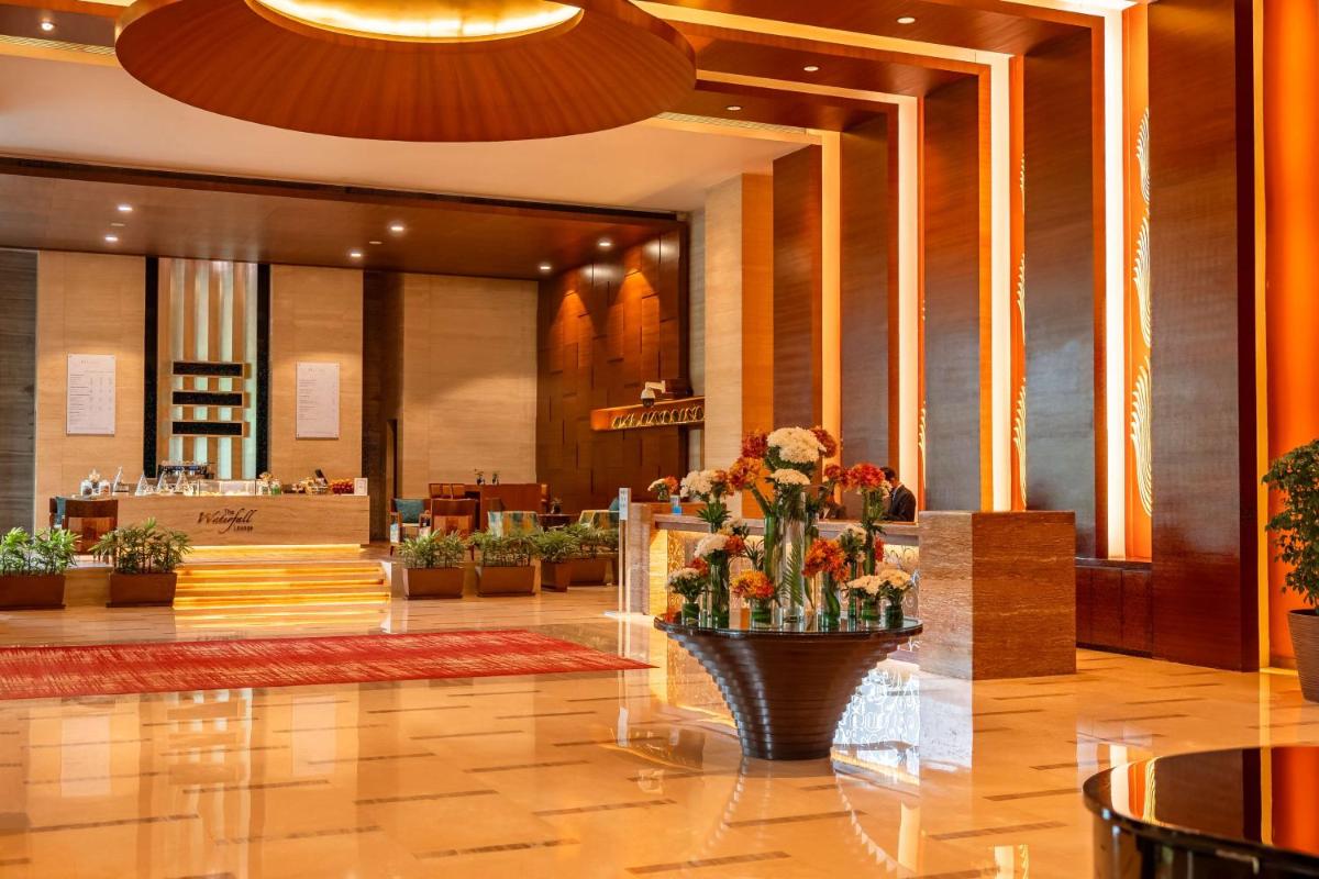 a lobby of a hotel with a vase of flowers at Hyatt Pune in Pune