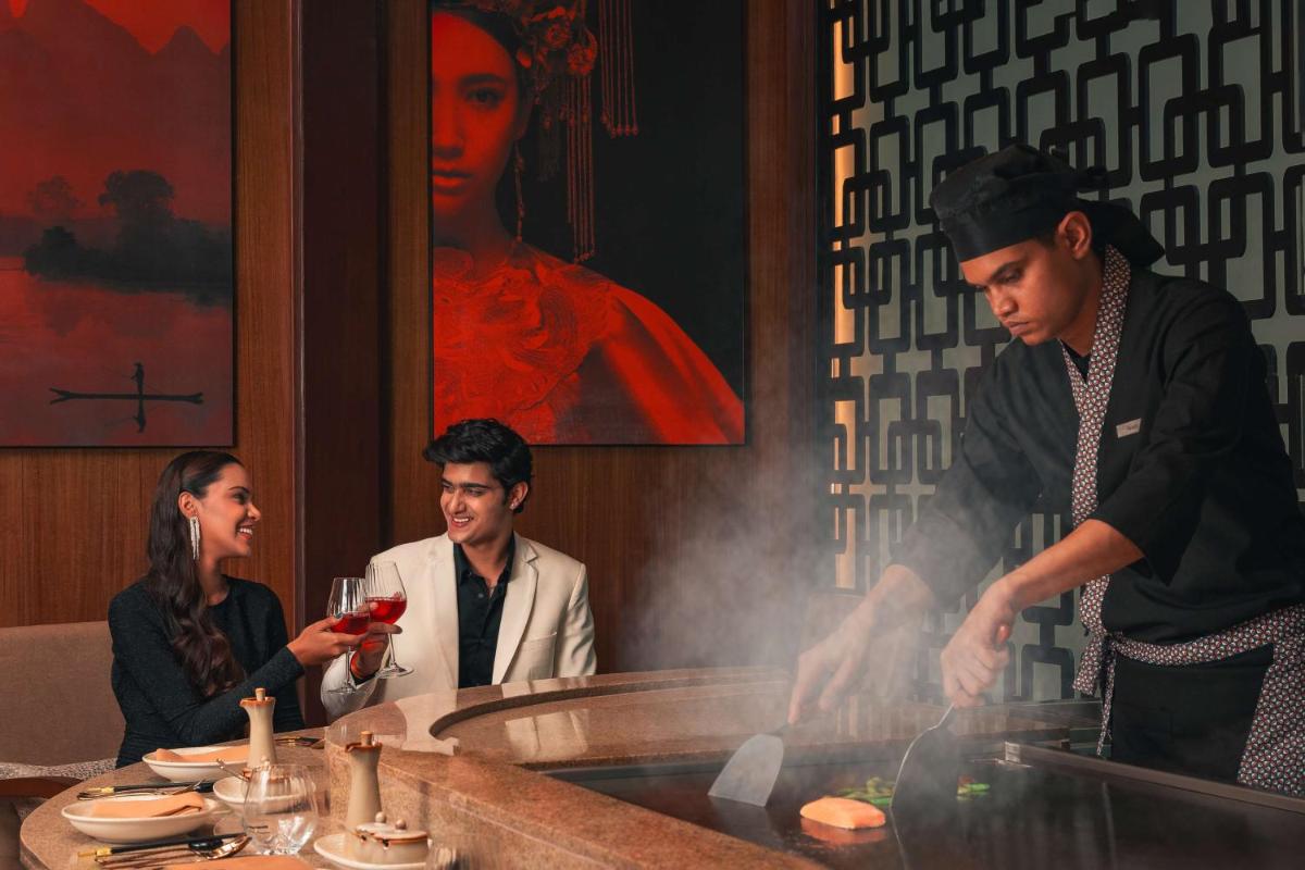 a group of people in a restaurant preparing food at Hyatt Pune in Pune