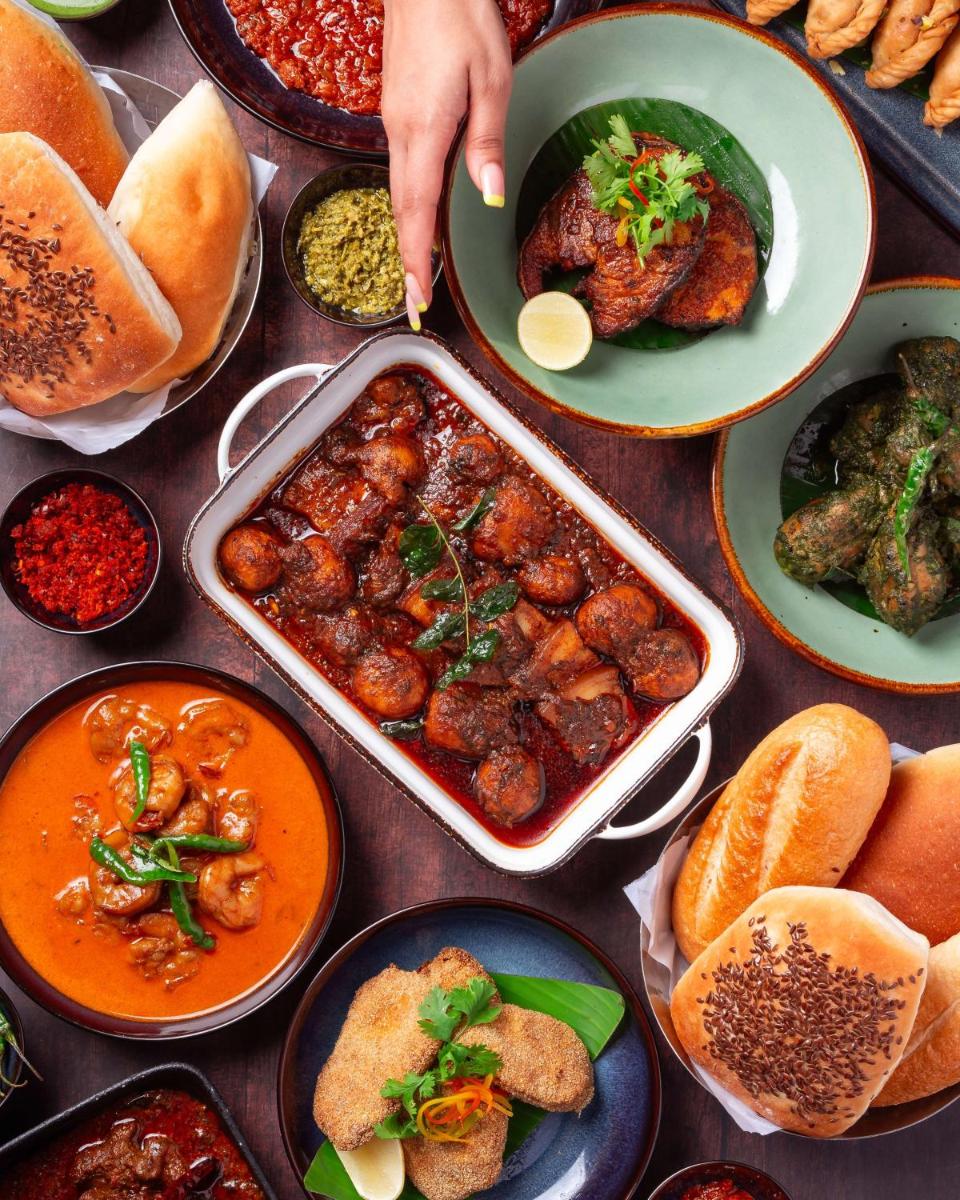 a table topped with bowls of food and plates of food at Hyatt Pune in Pune
