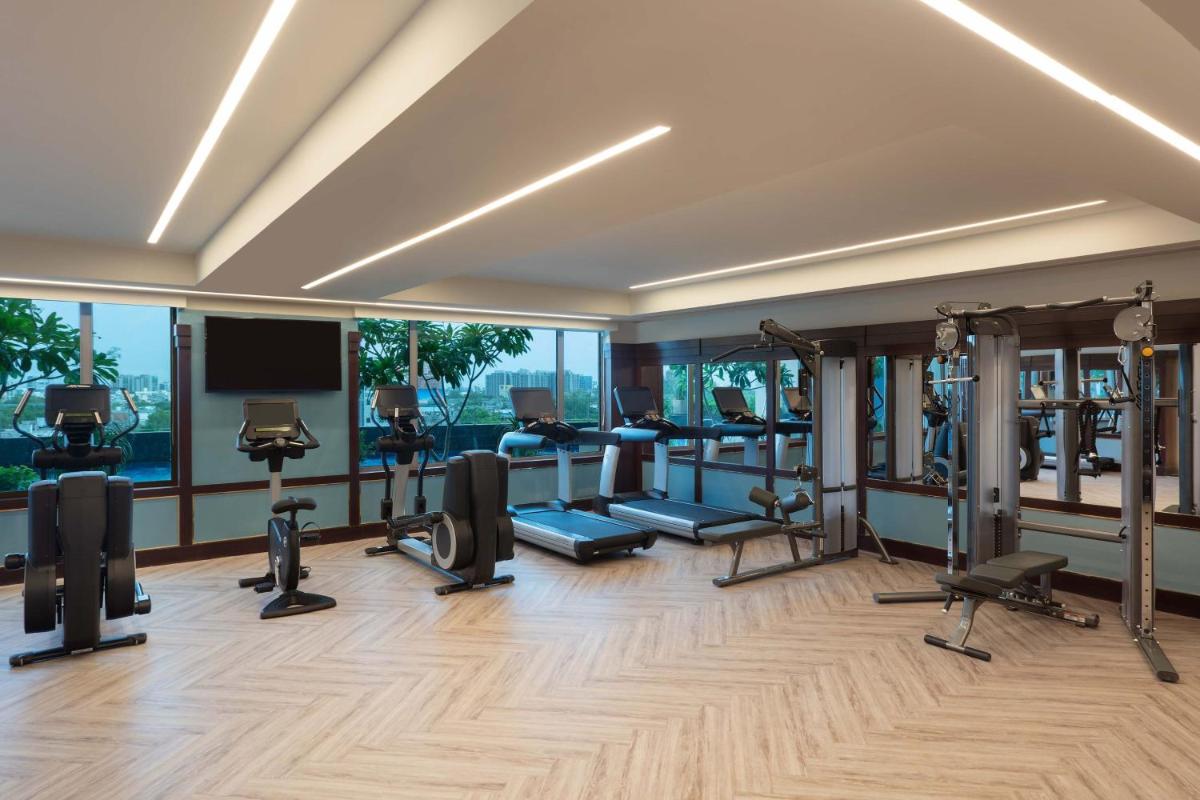 a gym with treadmills and elliptical machines at ITC Narmada, a Luxury Collection Hotel, Ahmedabad in Ahmedabad