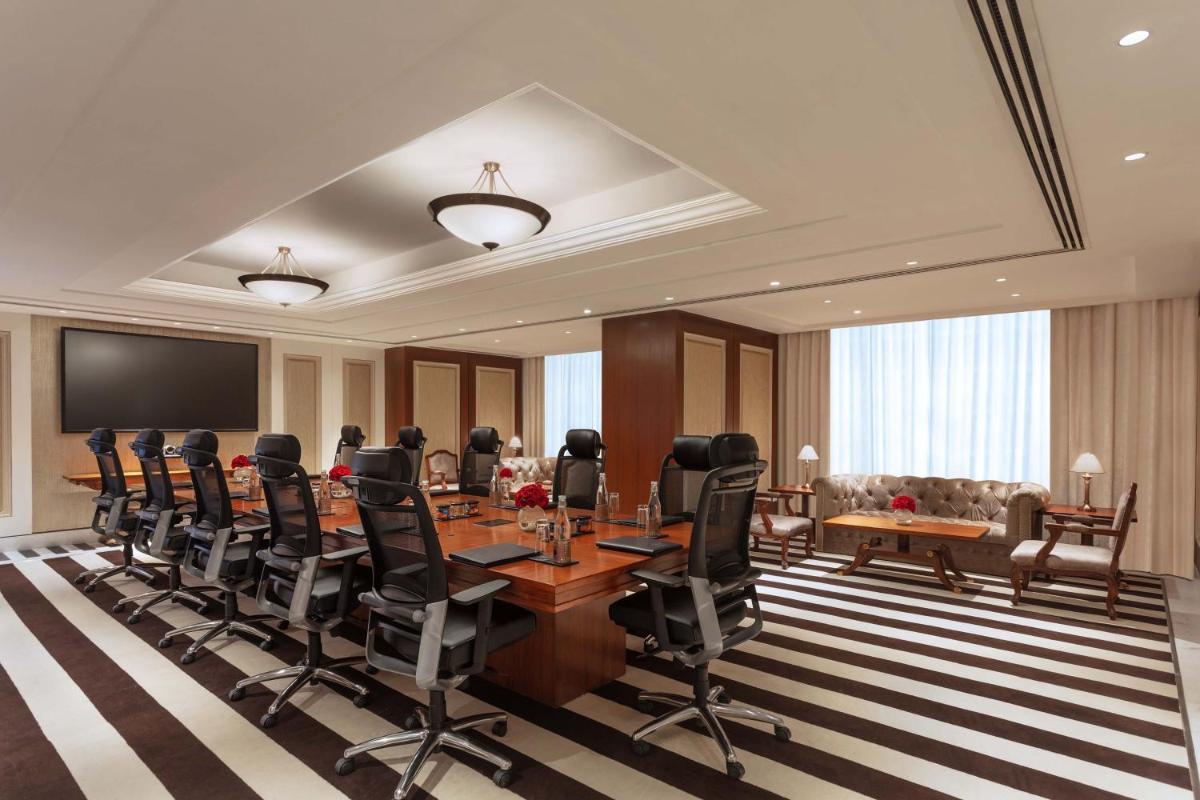 a conference room with a long table and chairs at ITC Narmada, a Luxury Collection Hotel, Ahmedabad in Ahmedabad