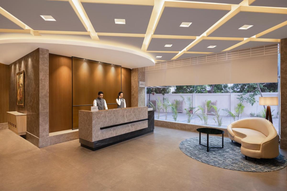 two people standing at a reception desk in a lobby at Fairfield by Marriott Jaipur in Jaipur