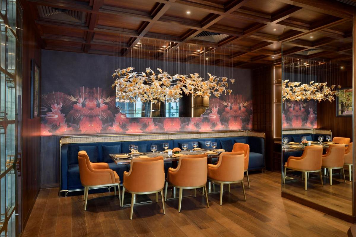 a dining room with a long table and chairs at Taj Amer, Jaipur in Jaipur
