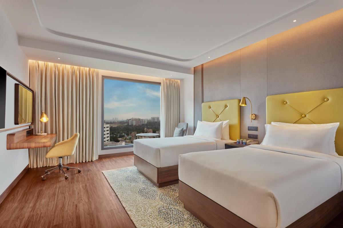 a hotel room with two beds and a window at Doubletree By Hilton Bengaluru Whitefield in Bengaluru +45 photos