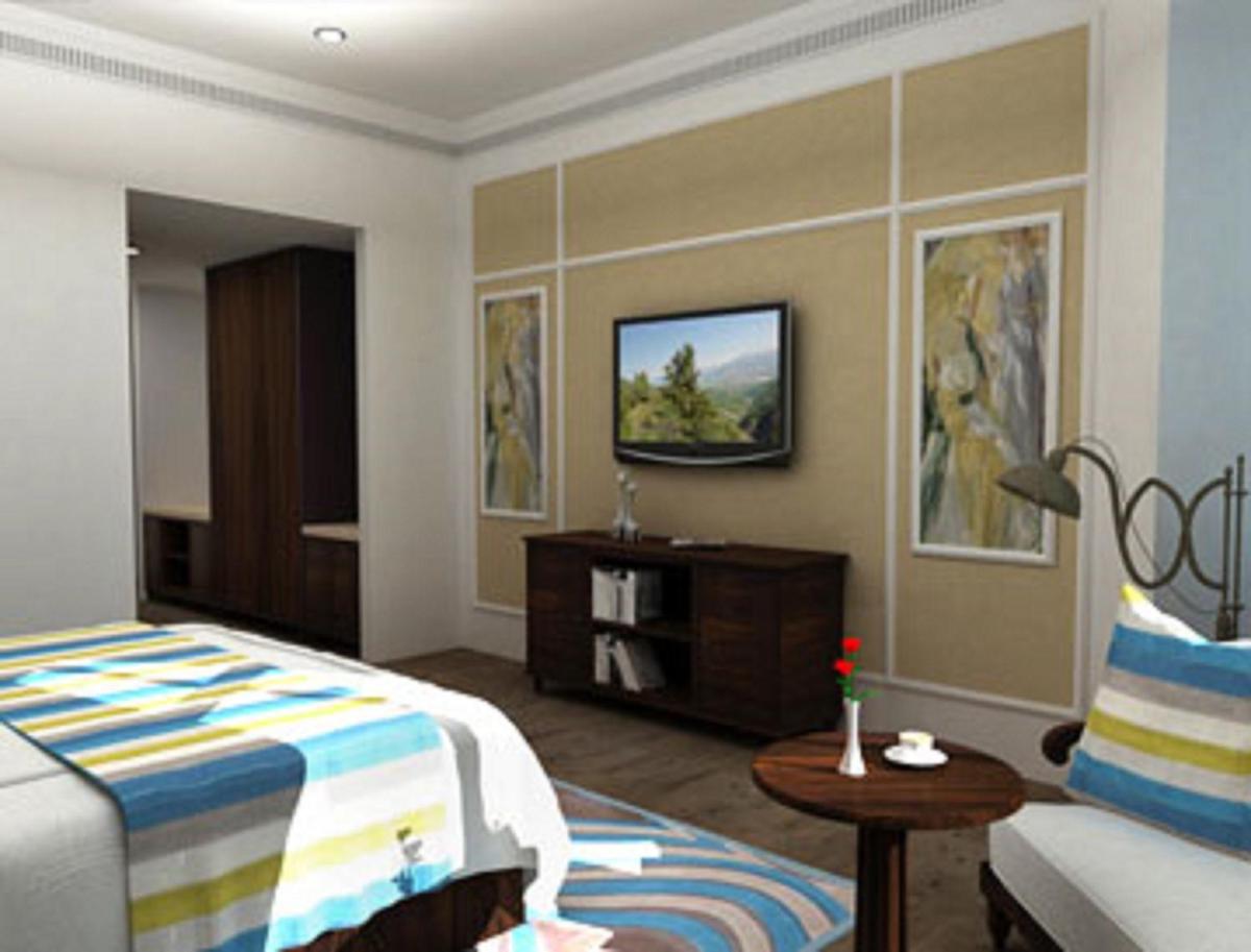 a hotel room with a bed and a tv at Fragrant Nature Kochi - A Five star Classified Hotel in Cochin