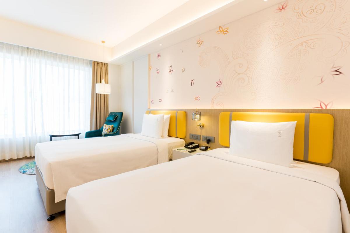 a hotel room with two beds and a window at Holiday Inn Lucknow Airport by IHG in Lucknow