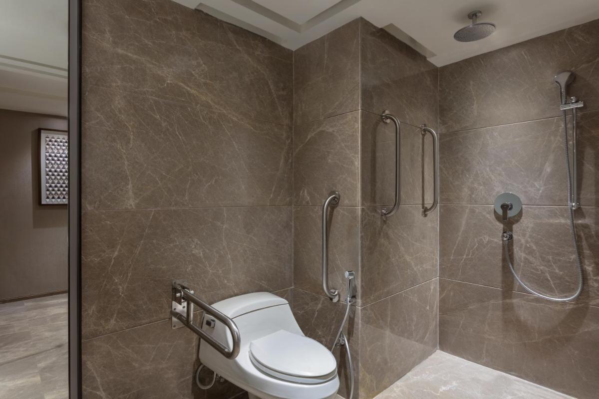 a bathroom with a shower with a toilet in it at Courtyard by Marriott Amritsar in Amritsar